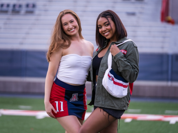 University of Arizona undergraduate students Erika Gay (right) and Jade Butcher model clothing and accessories from the Arizona Replay clothing line, which incorporates retired UArizona football jerseys and thrifted clothing.Drew Bourland/University of Arizona Marketing and Brand Management